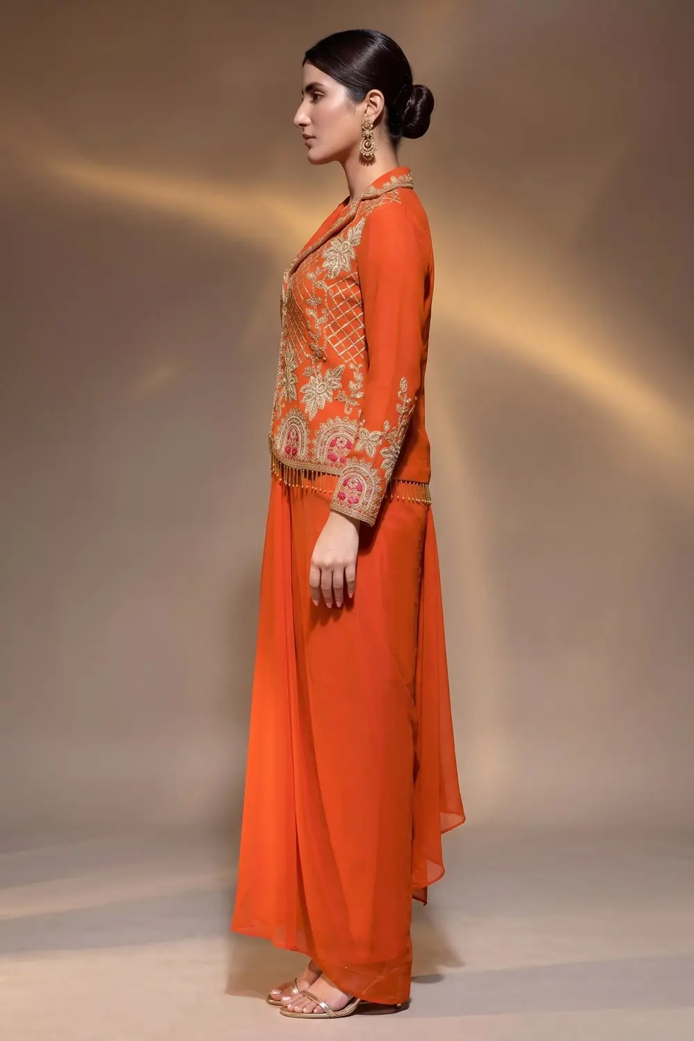 Side view of orange dress jacket and cowl skirt set by Khaish