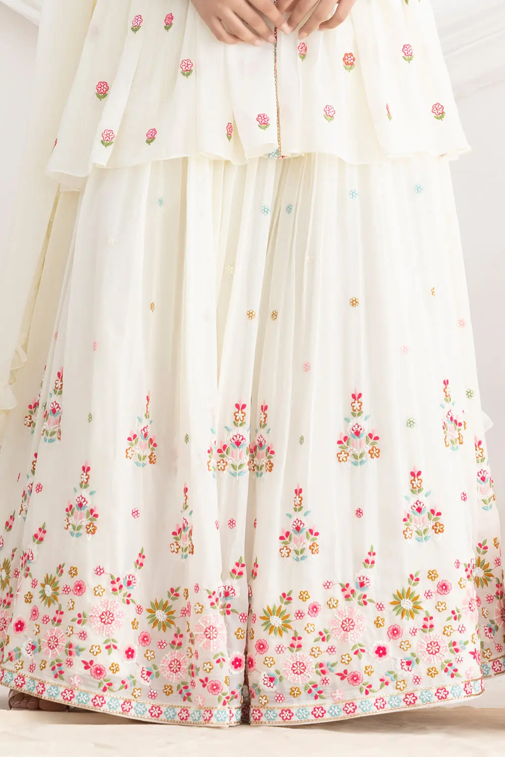 Allover pleated white lehenga with floral silk and beads work