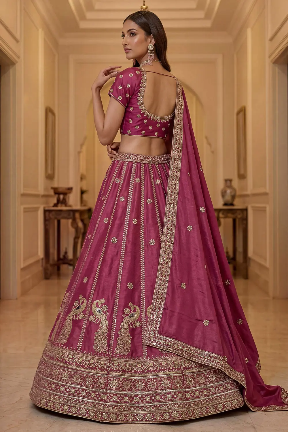 Delicate lacework detailing on pink silk lehenga border