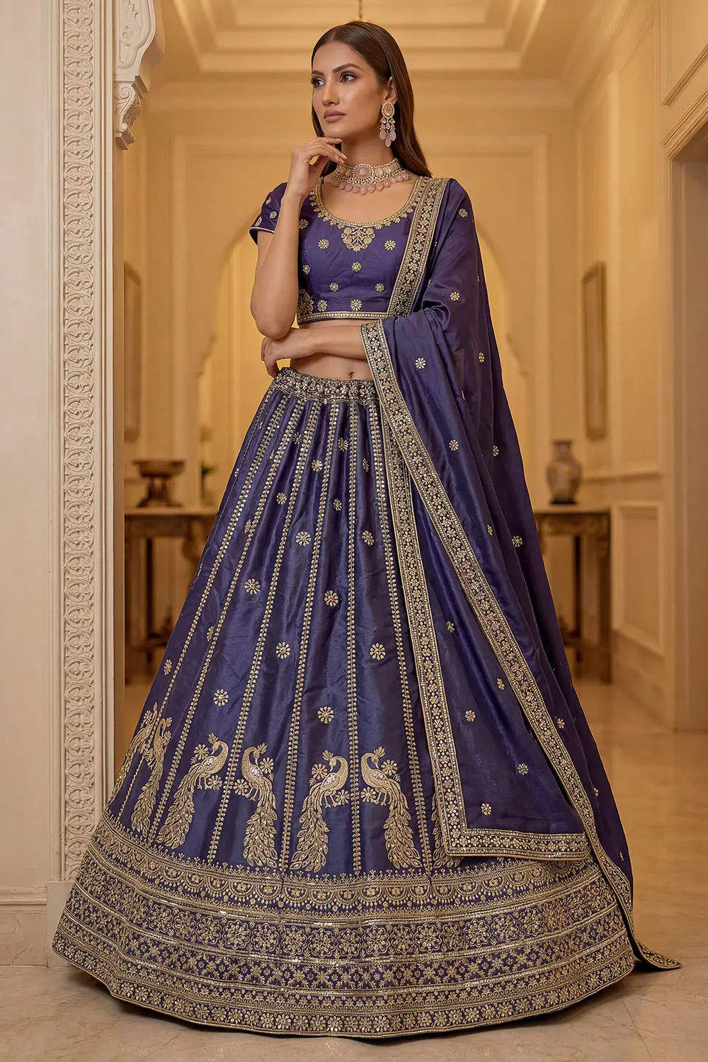 Peacock blue silk lehenga styled with matching embroidered blouse and dupatta