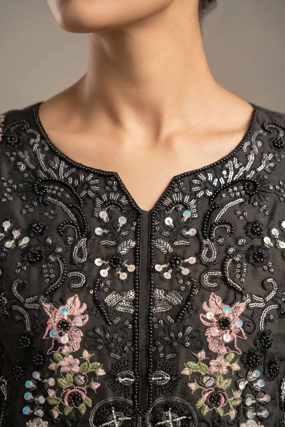 Close up of embroidered black chiffon kurta top with beadwork