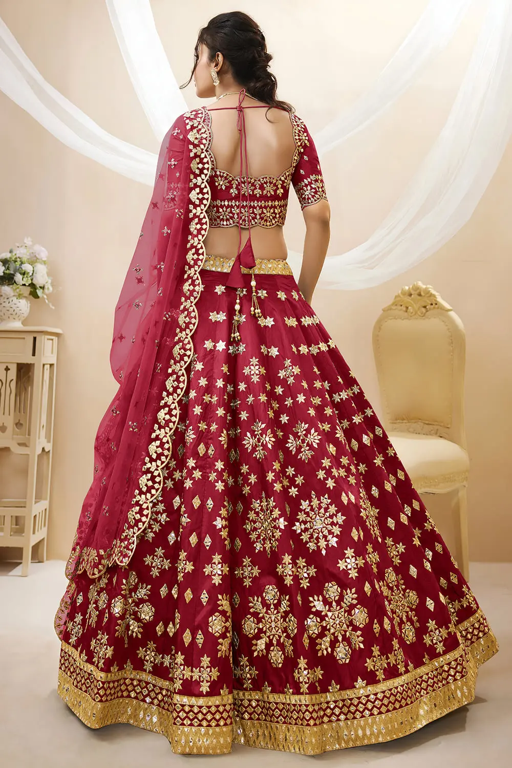 Back view of red art silk lehenga choli with embroidered blouse