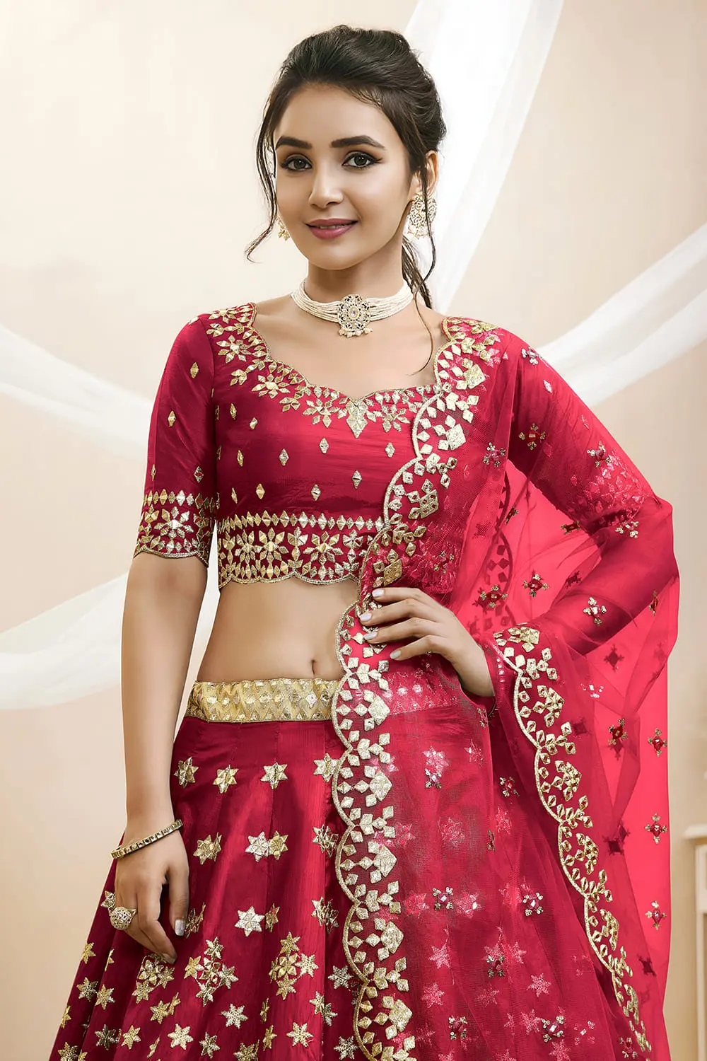 Close up of sequins, foil and zari work on red art silk lehenga