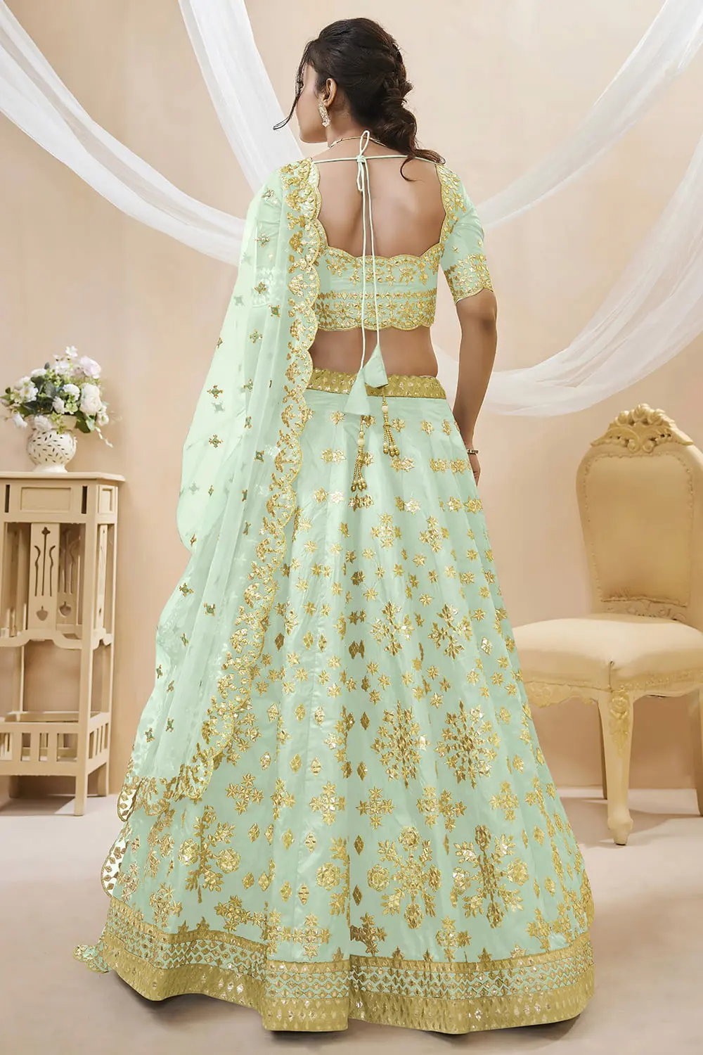 Back view of pista green art silk lehenga choli with embroidered blouse