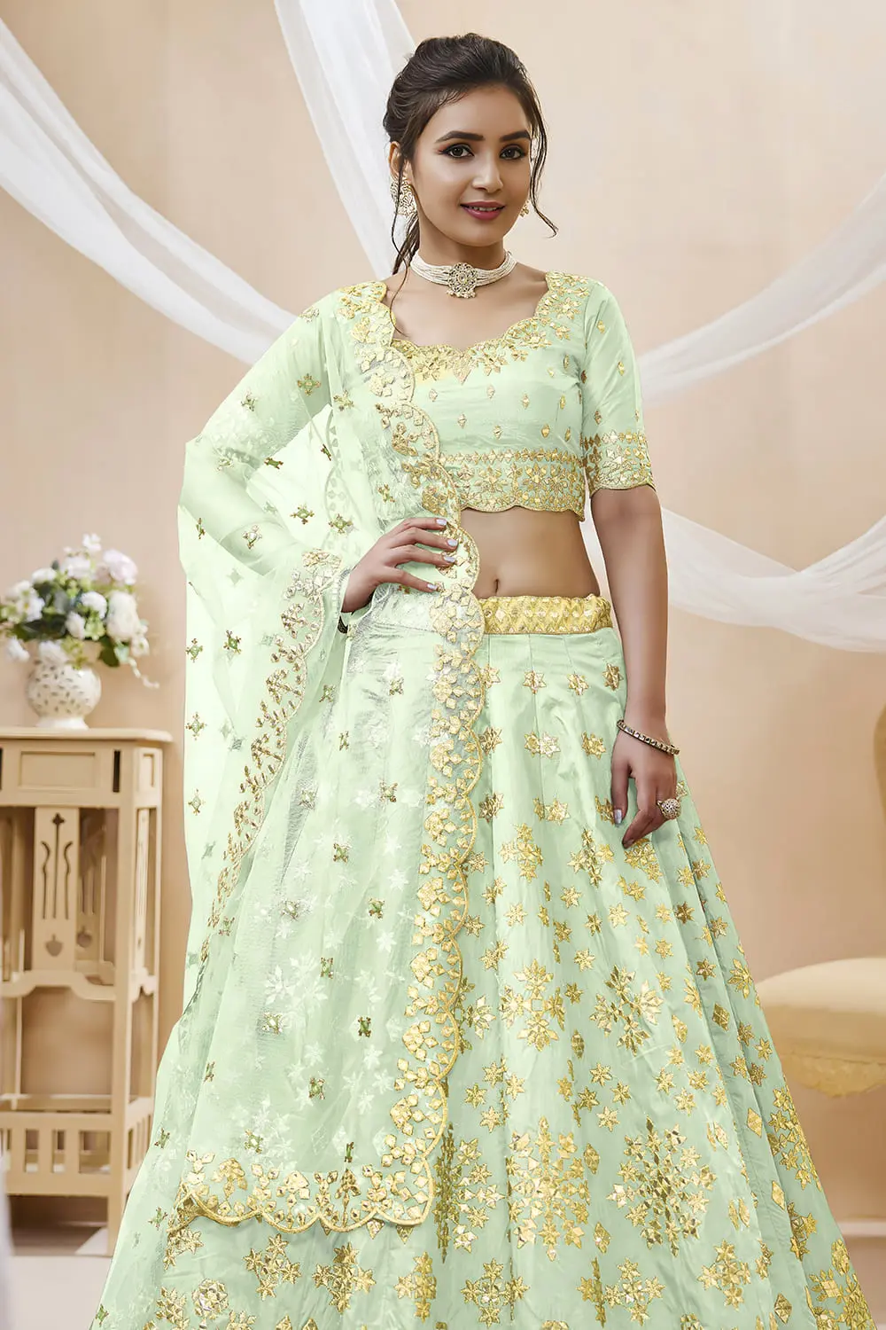 Close up of sequins, foil and zari work on pista green art silk lehenga