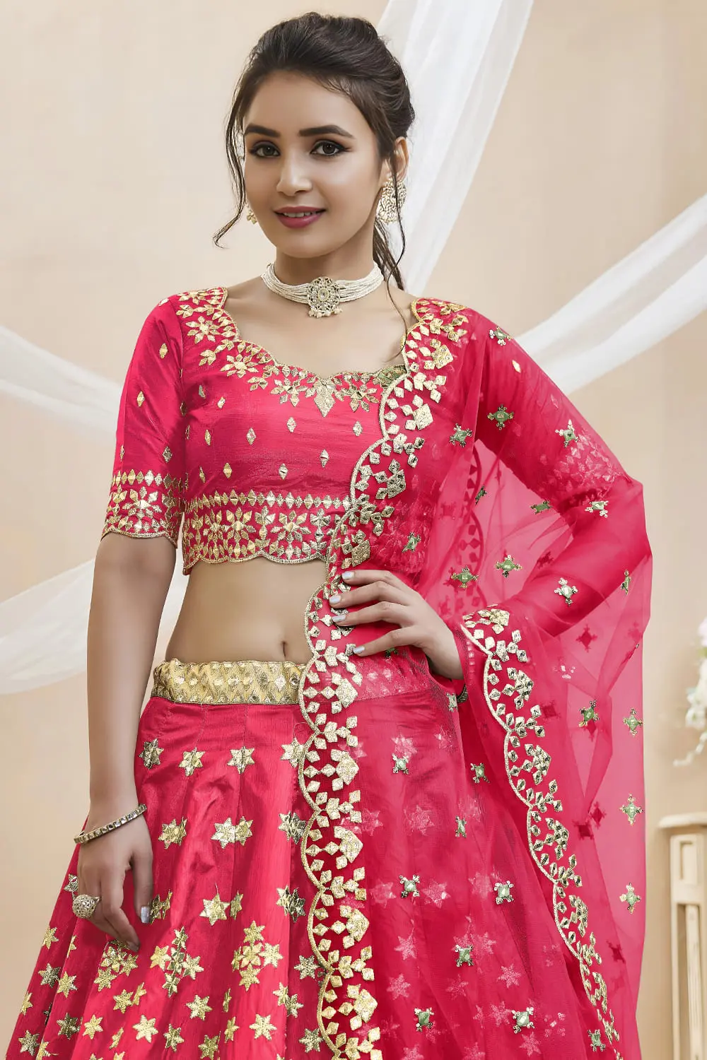 Close up of sequins, foil and zari work on pink art silk lehenga