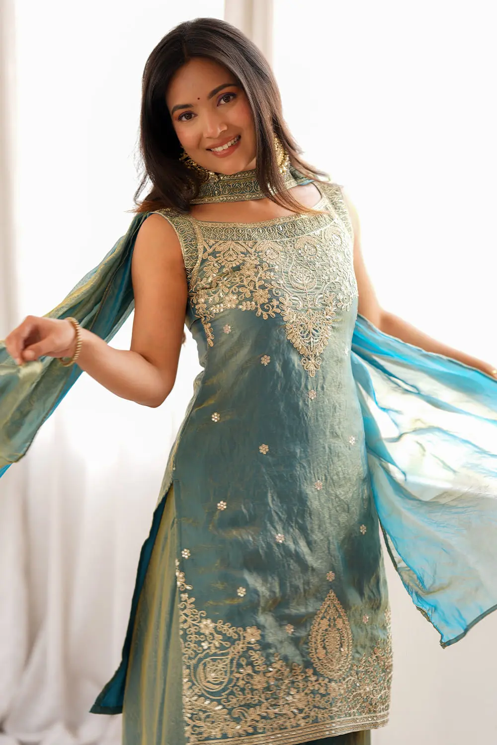 Close up of fancy colour lace belt on teal green silk dupatta