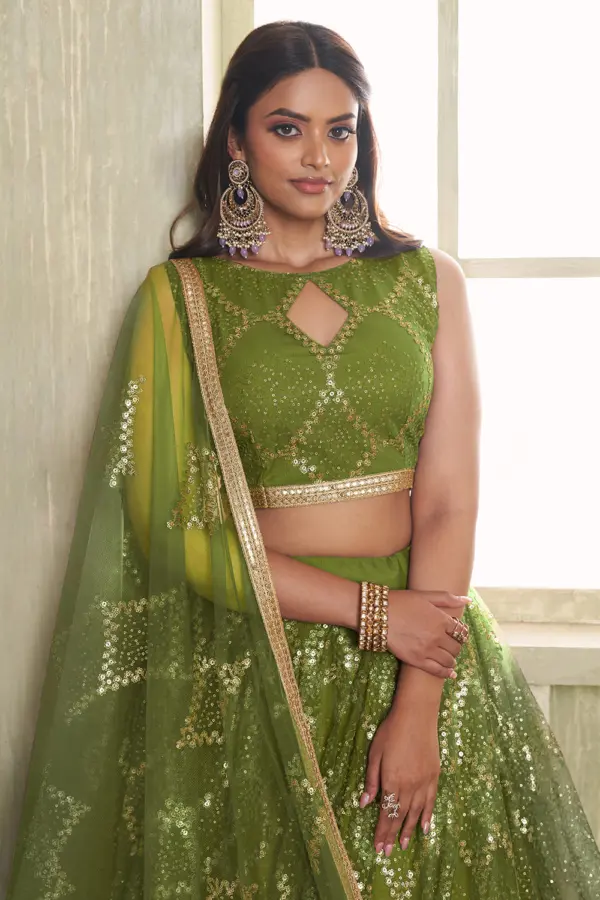 Close up of tone-to-tone thread work and glitter sequins on green net lehenga