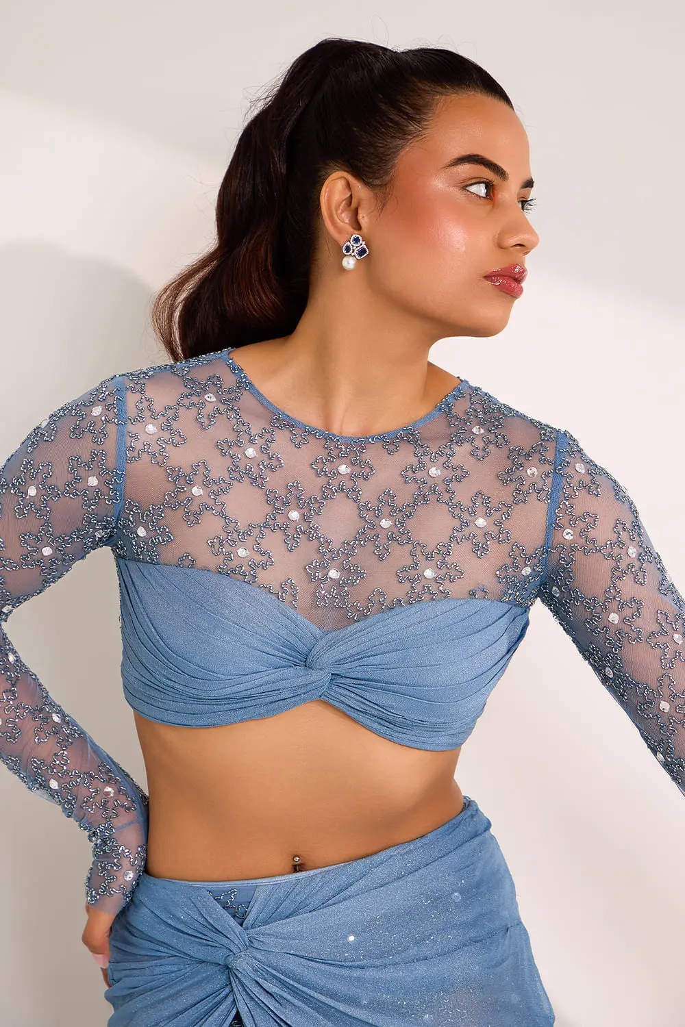 Close up of cut dana and crystal embroidery on blue knot skirt