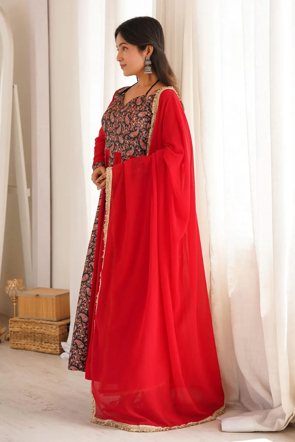 Side view of red anarkali gown with pant showing flowing flare