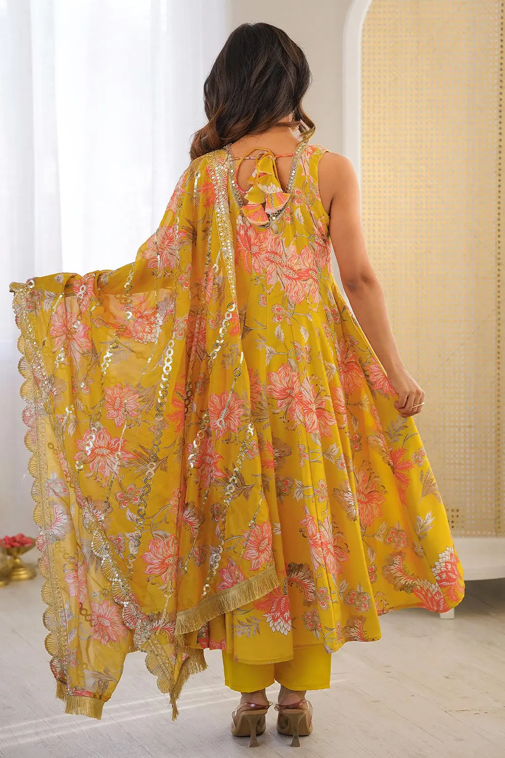 Back view of mustard muslin anarkali gown with pant