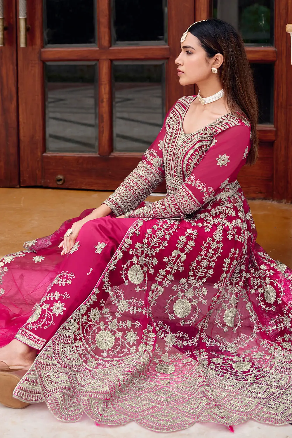 Heavy front embroidery and stone work on pink butterfly net anarkali
