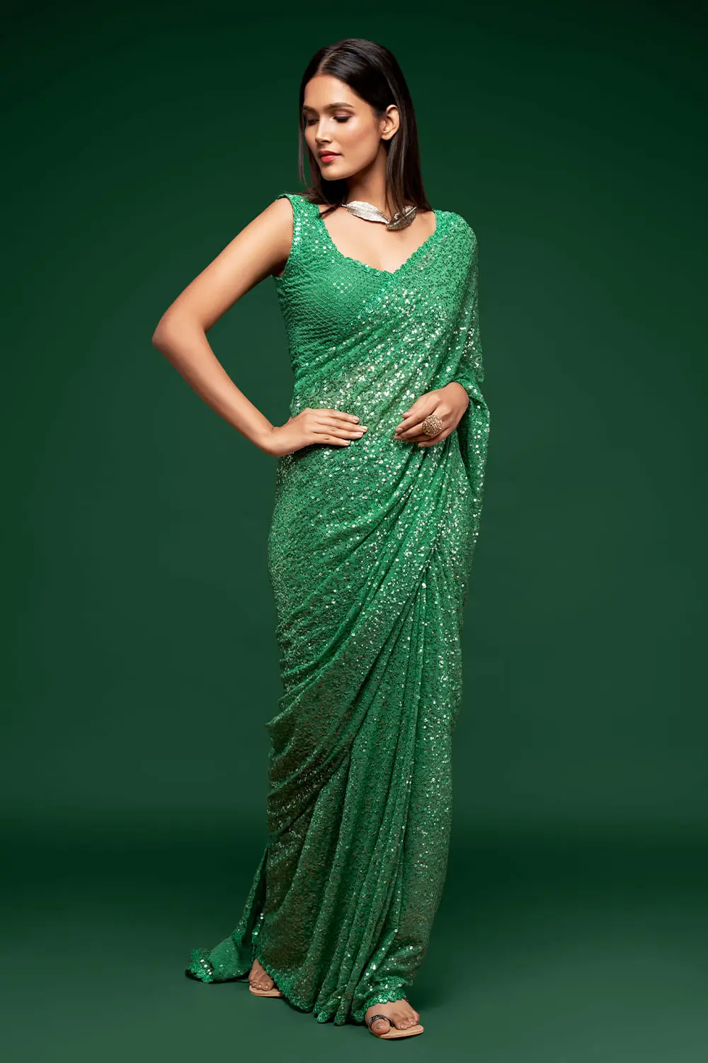 Side angle view of mint green saree drape with embroidery detail