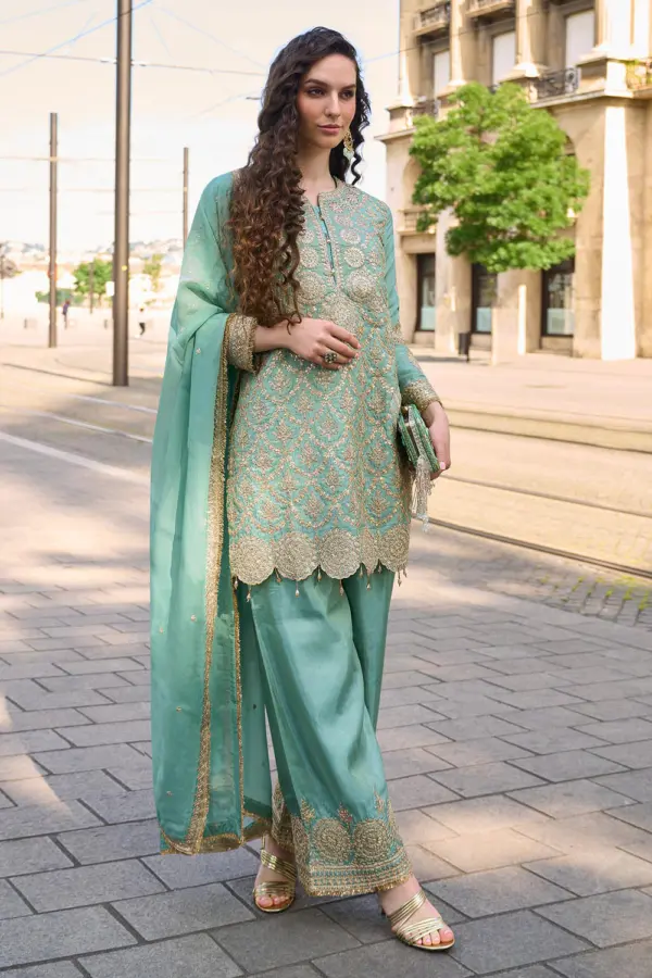 Sea green silk embroidered kurta set with hand mirror work by Khaish