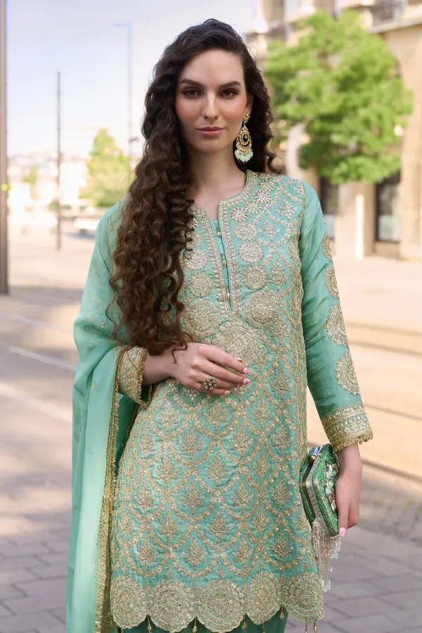 Close up of hand mirror embellishment and heavy embroidery on sea green premium silk kurta top