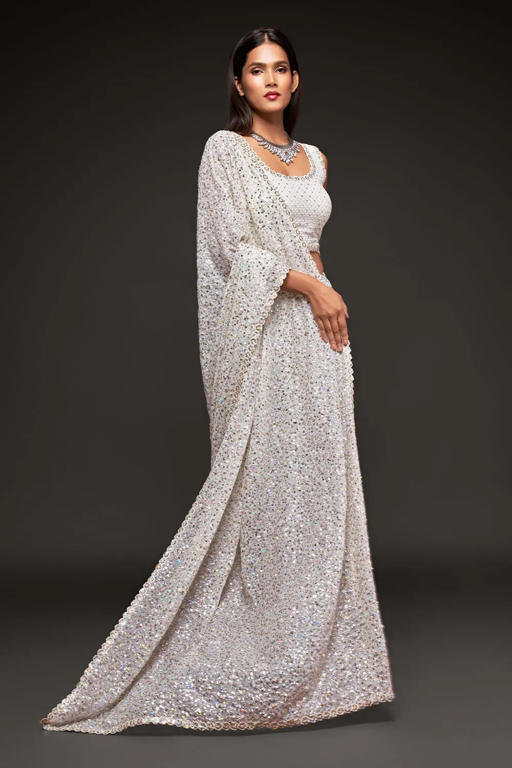 Side profile of off white georgette saree drape with sequin detail