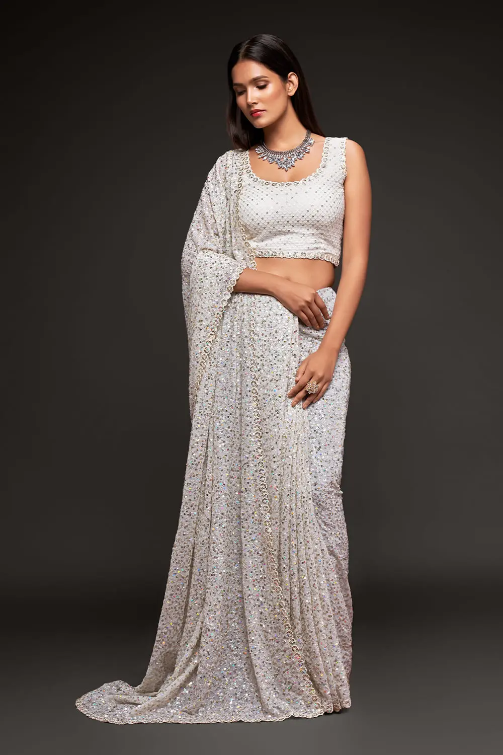 Off white sequin georgette saree with pallu draped full view