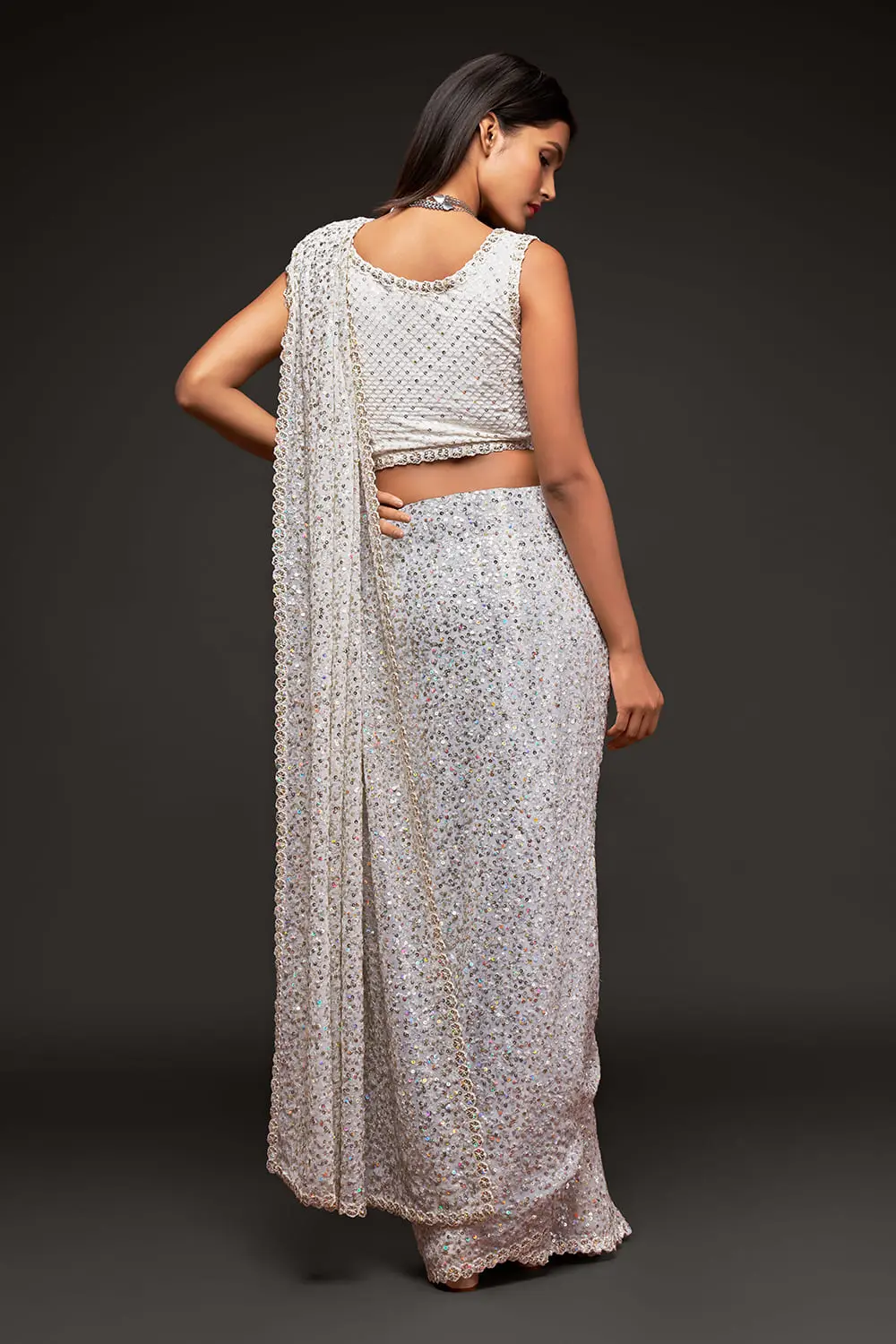 Back view of off white georgette saree with sequin work