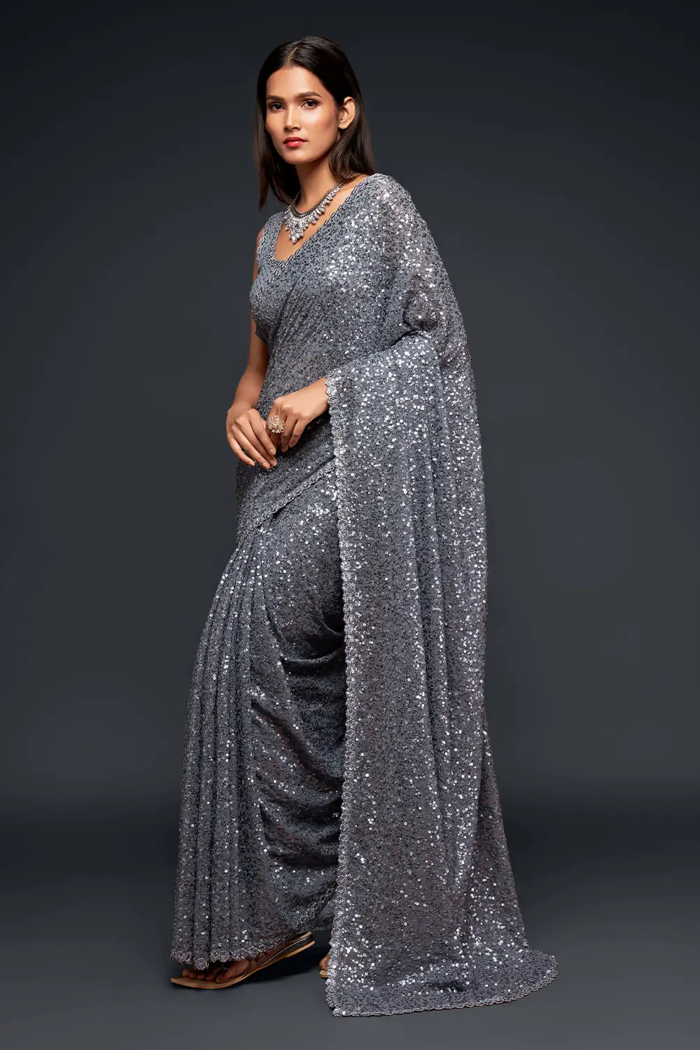 Side profile of slate grey georgette saree drape with sequin detail