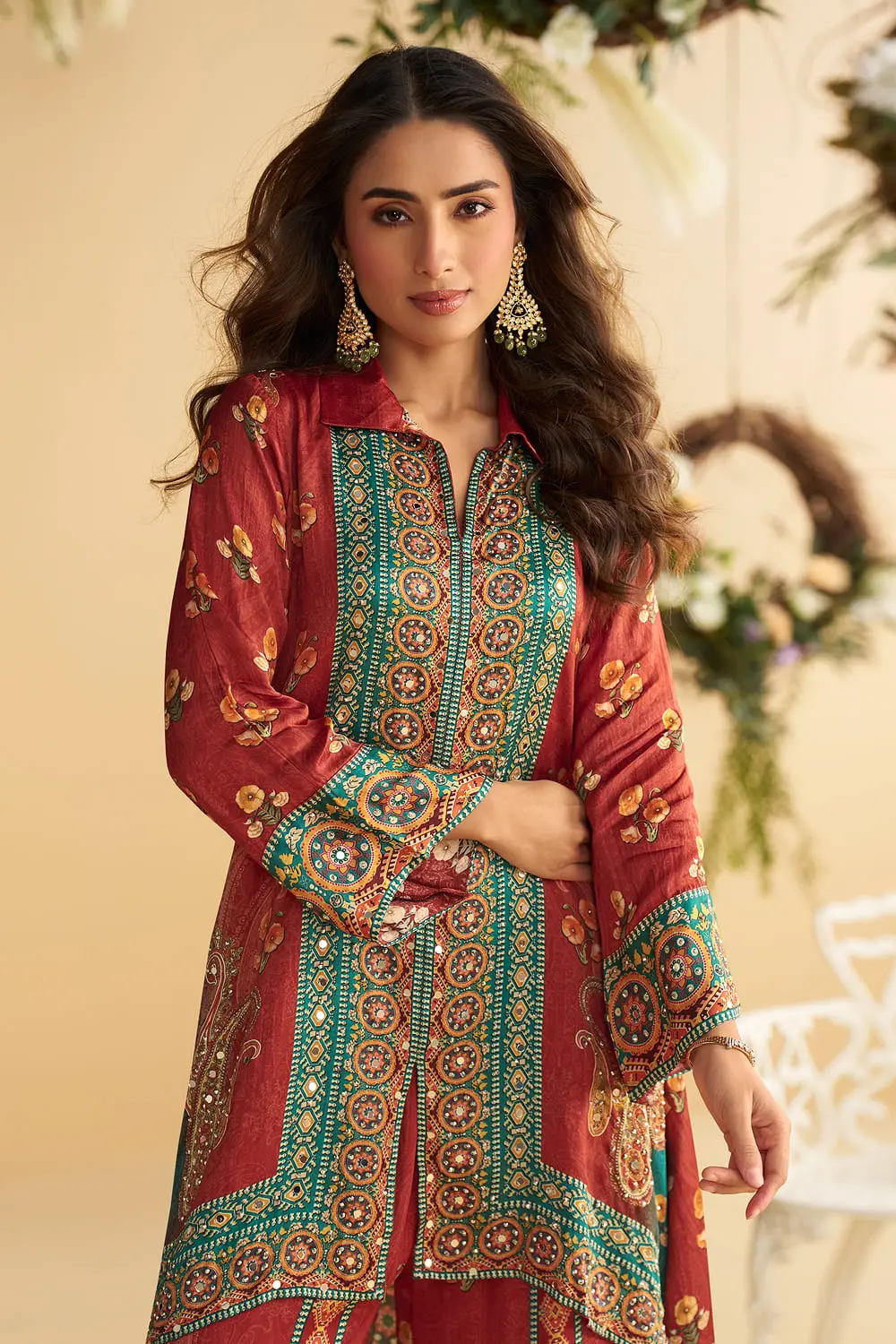 Close up of hand mirror embellishment on the rust and teal blue crepe silk kurta