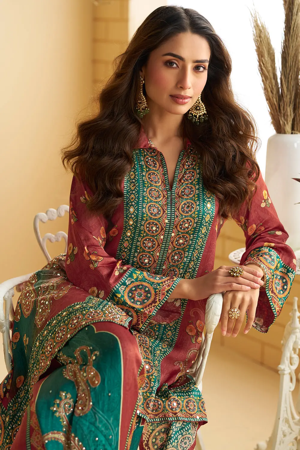 Close up of shisha mirror work at the motif border of the rust teal crepe silk kurta