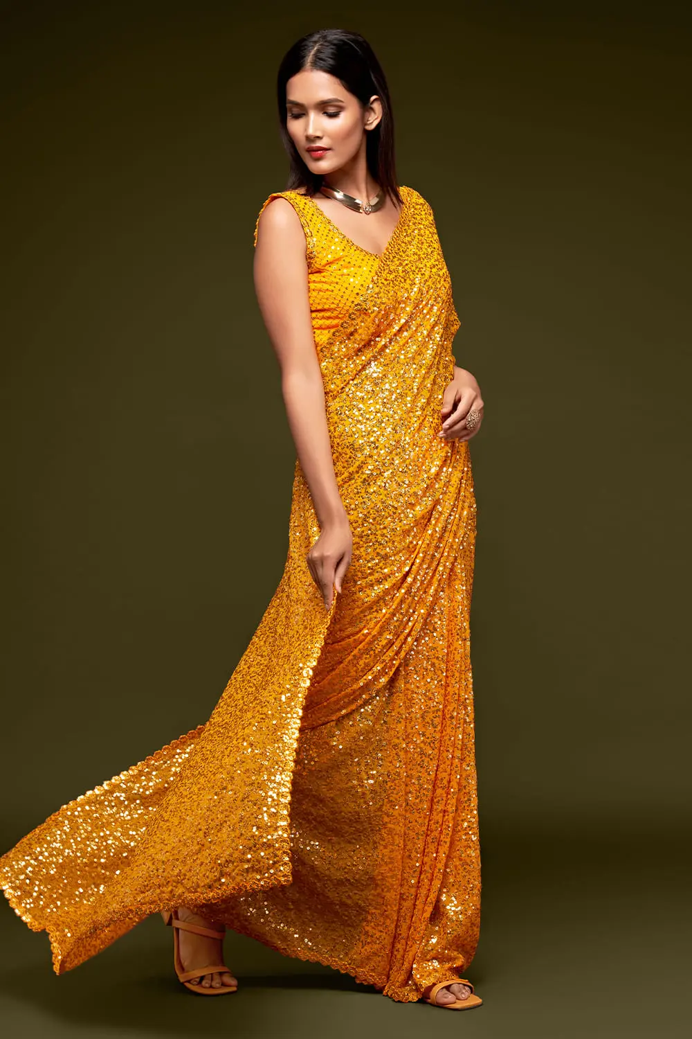 Side angle view of honey yellow georgette saree drape with sequin detail