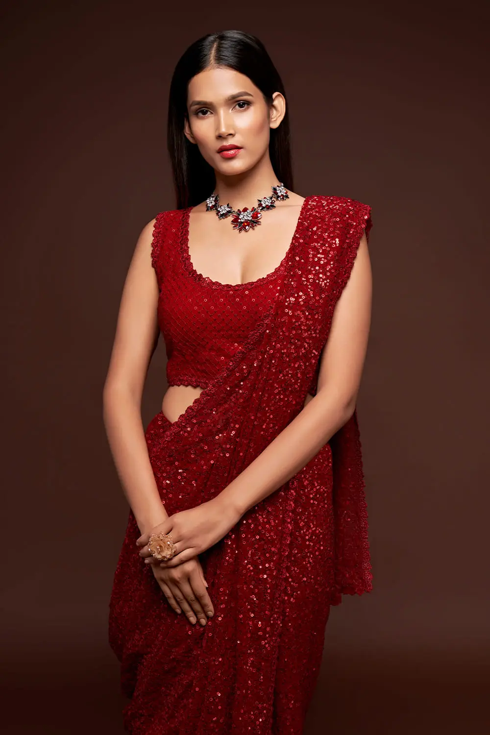 Close up of sequin work border detail on ruby red georgette saree