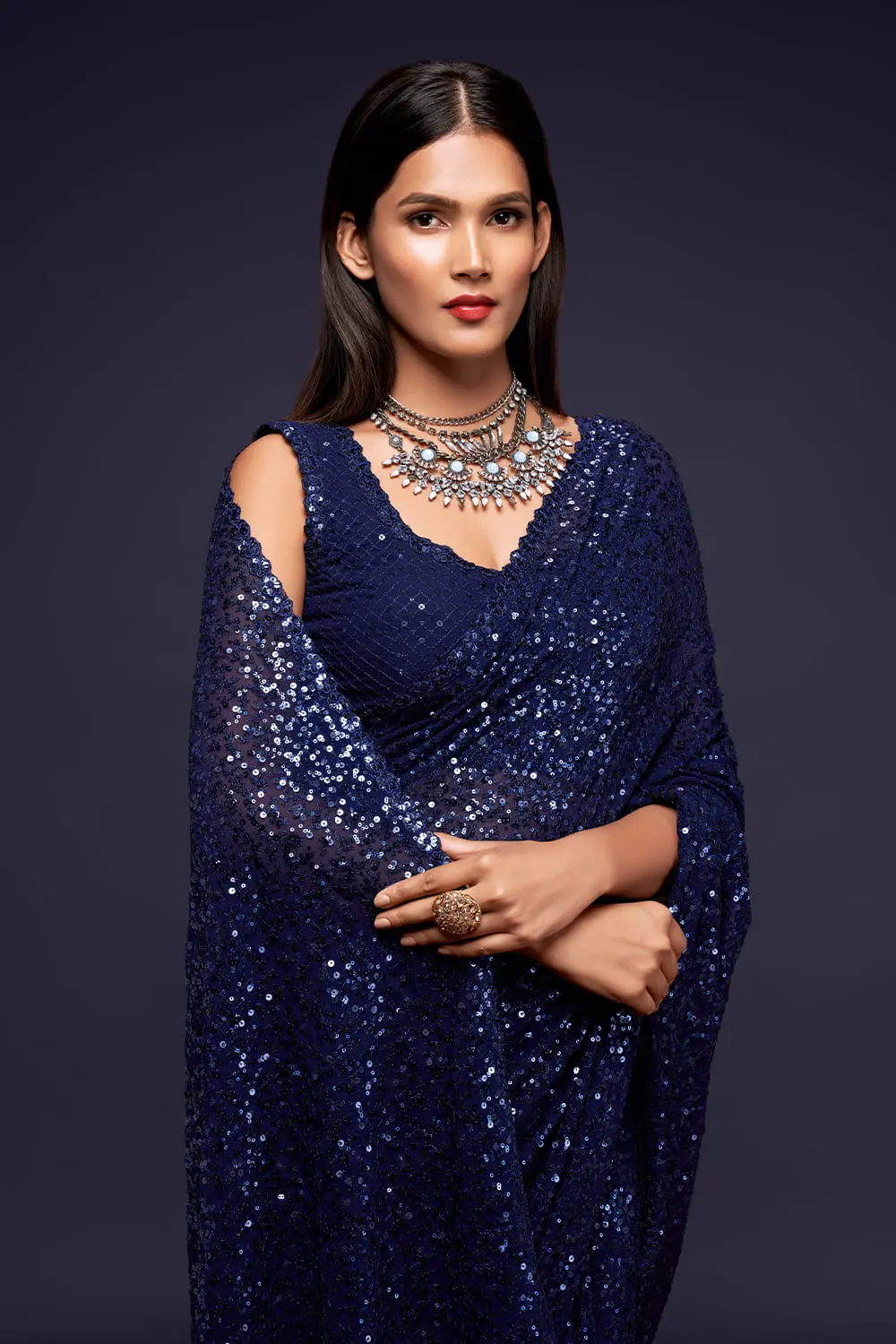 Close up of thread embroidery and multiple sequins on blush blue saree