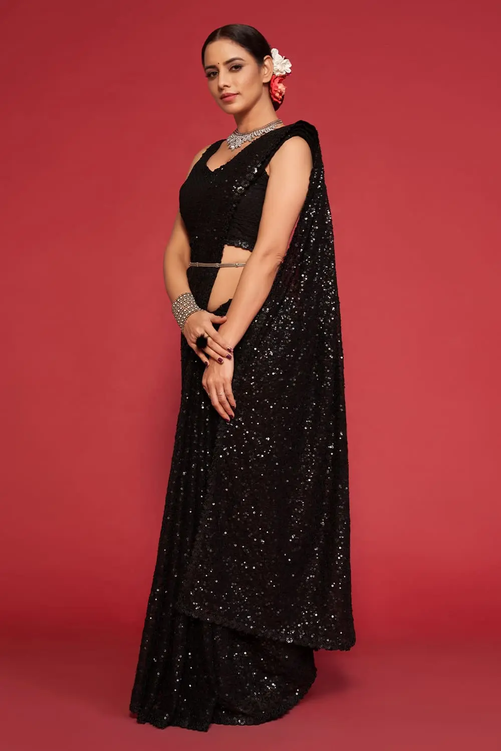 Side angle view of black georgette saree drape with sequin detail