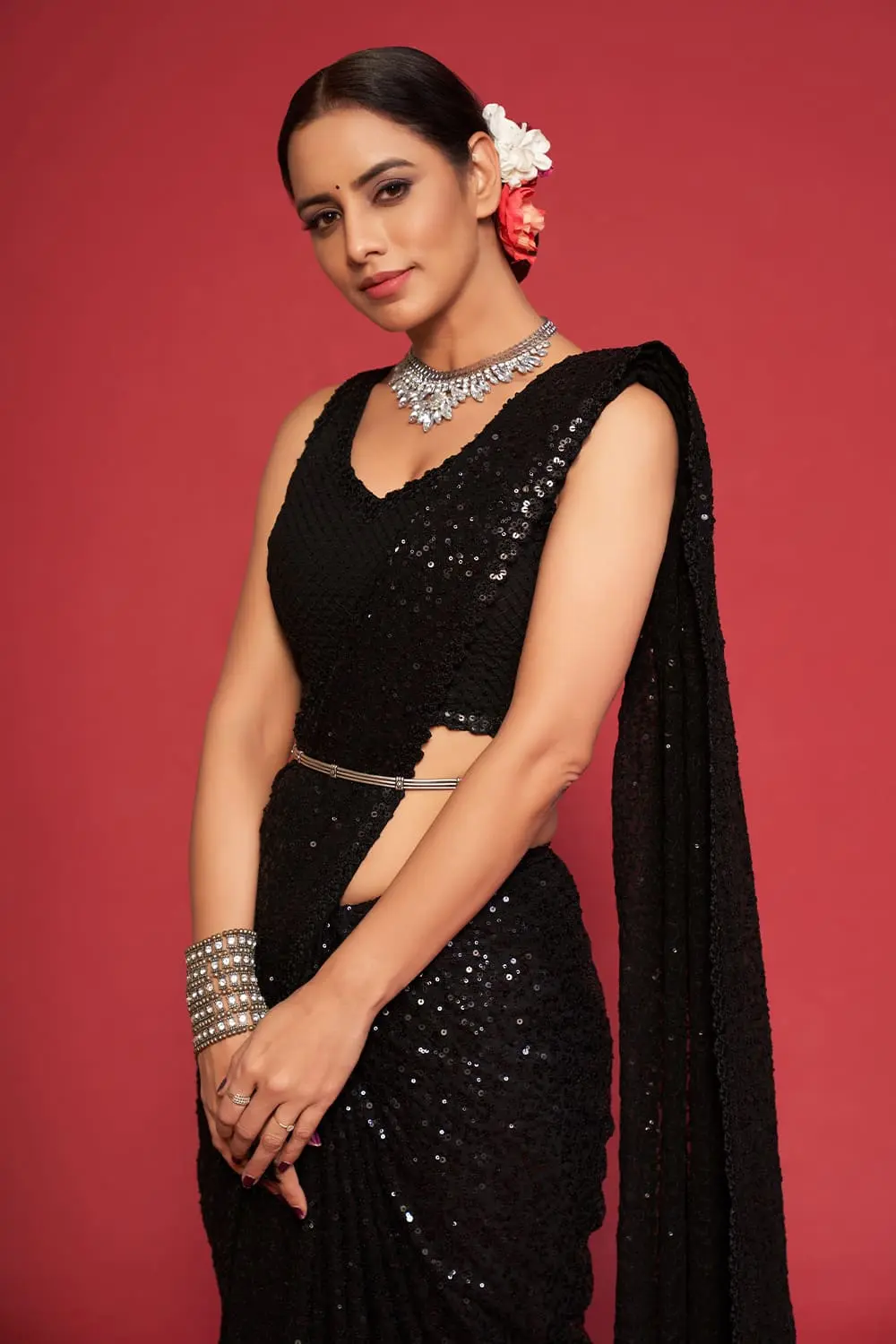 Close up of thread embroidery and multiple sequins on black georgette saree