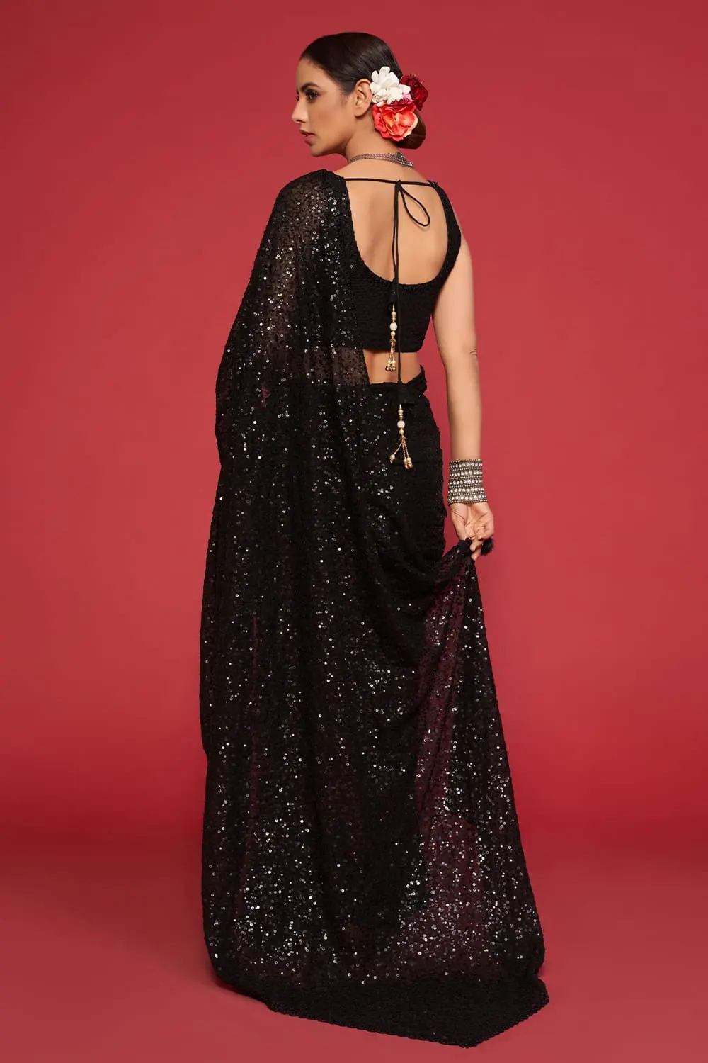 Back view of black georgette saree with dense sequin work