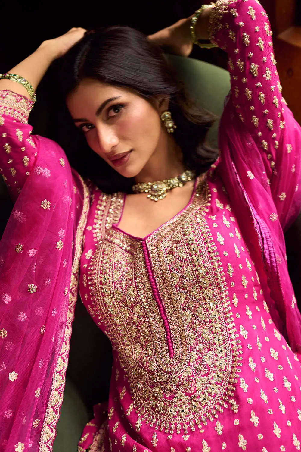 Close up of hand mirror embroidery across the front of the hot pink kurti lehenga