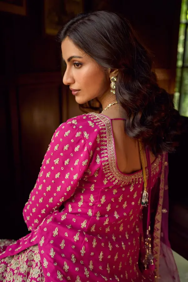 Back view of hot pink kurti lehenga showing the full back mirror embroidery coverage