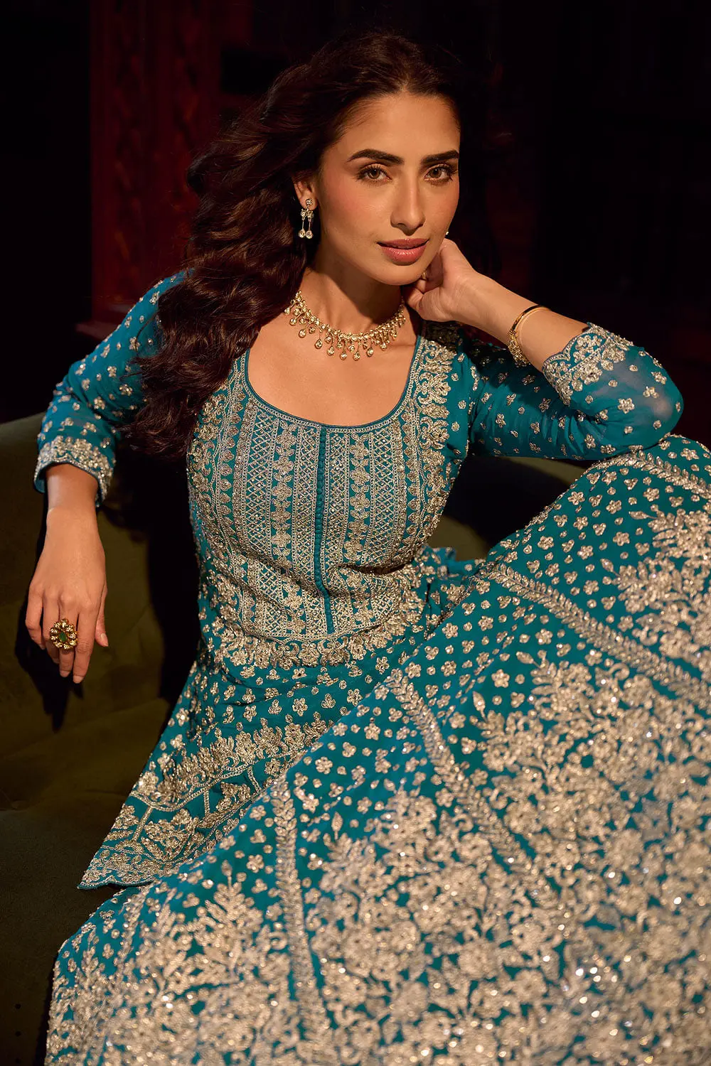 Close up of hand mirror embroidery across the front of the teal blue georgette kurti top