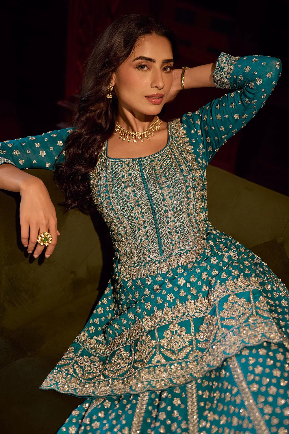 Close up of shisha mirror work and thread detail on the teal blue kurti lehenga surface