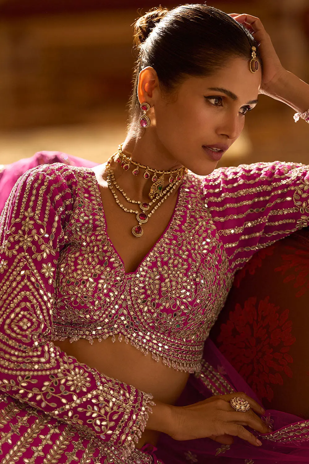 Close up detail of the embroidered hot pink silk blouse and lehenga junction