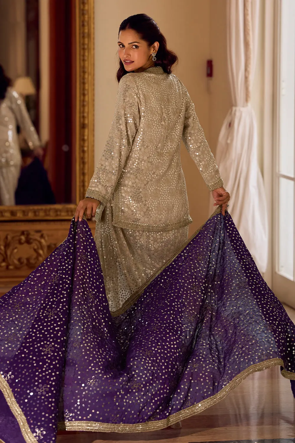 Elegant back drape and fit of the beige and purple ethnic designer outfit.