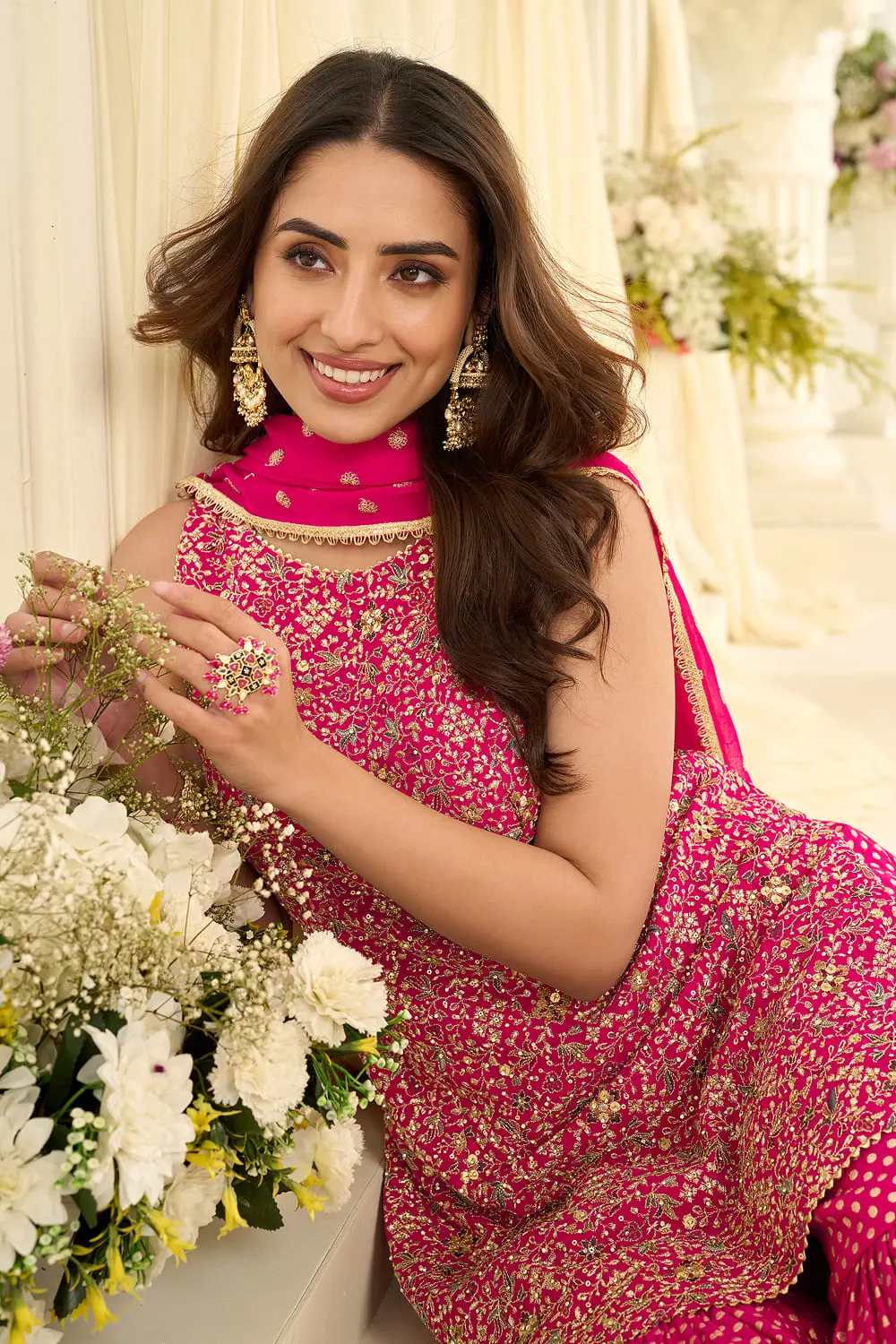 Close up of embroidery and stone work on hot pink gharara set