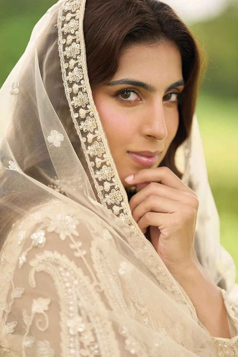 Close up of heavy beads embroidery on light gold net palazzo and dupatta surface