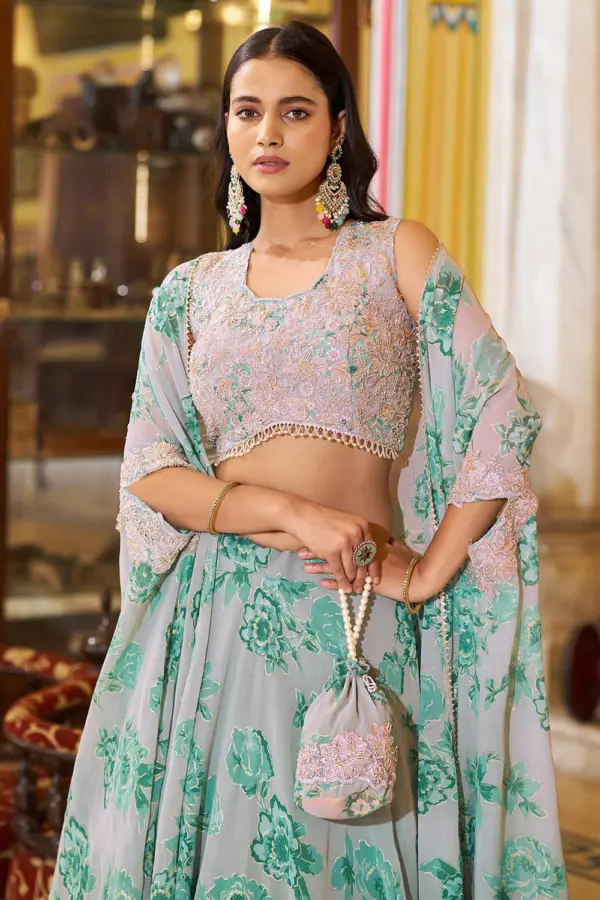 Close up of thread embroidery, sequins and tube beads on dusty green lehenga