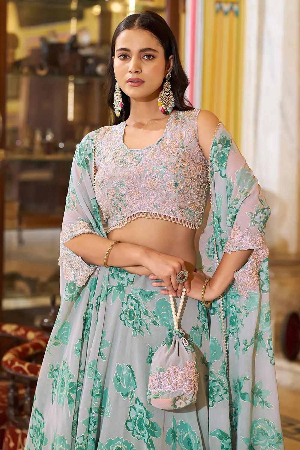 Close up of thread embroidery, sequins and tube beads on dusty green lehenga