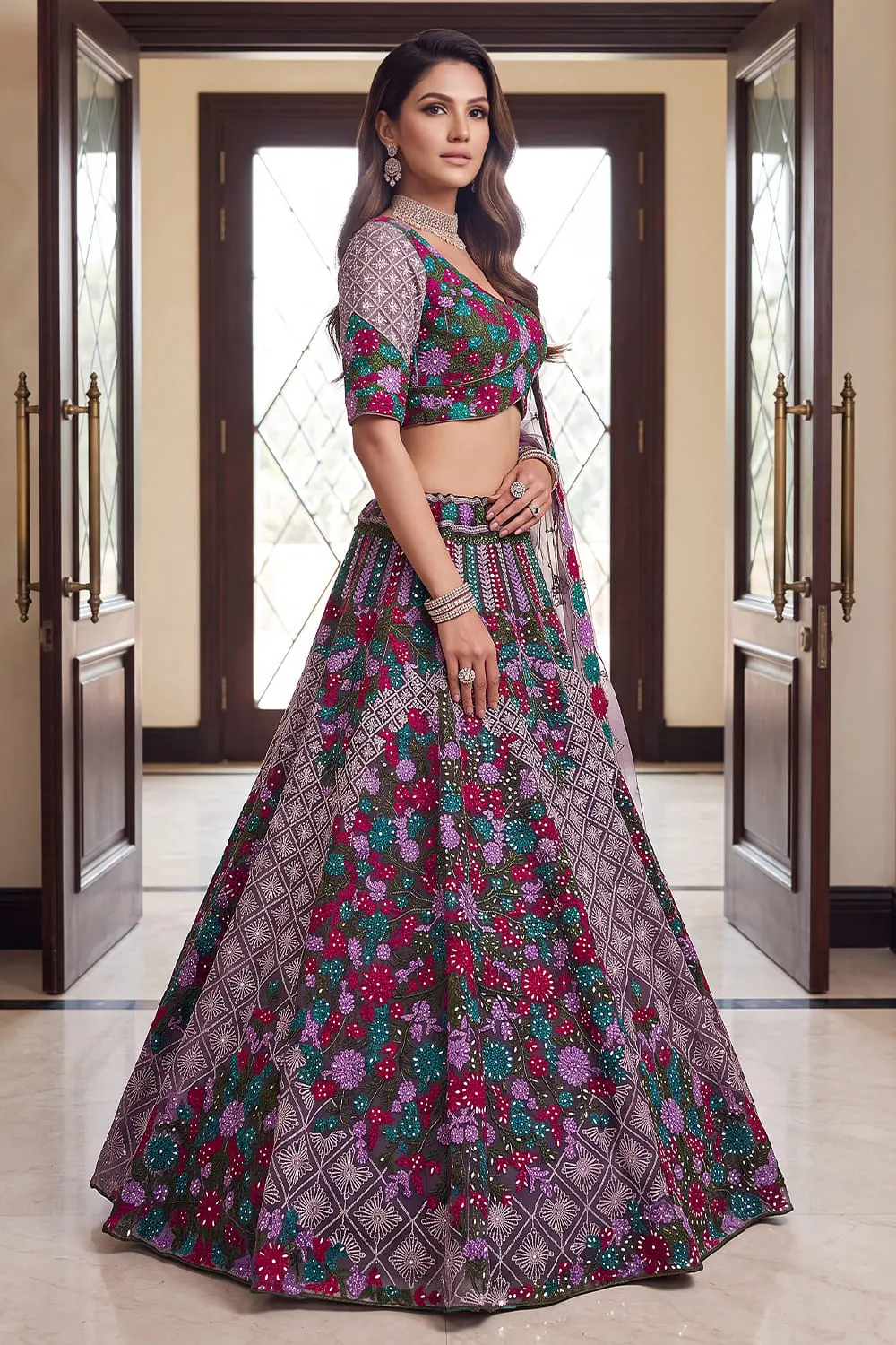 Side angle of the purple A-line lehenga showing the fall of the heavy net panel and lace-edged dupatta