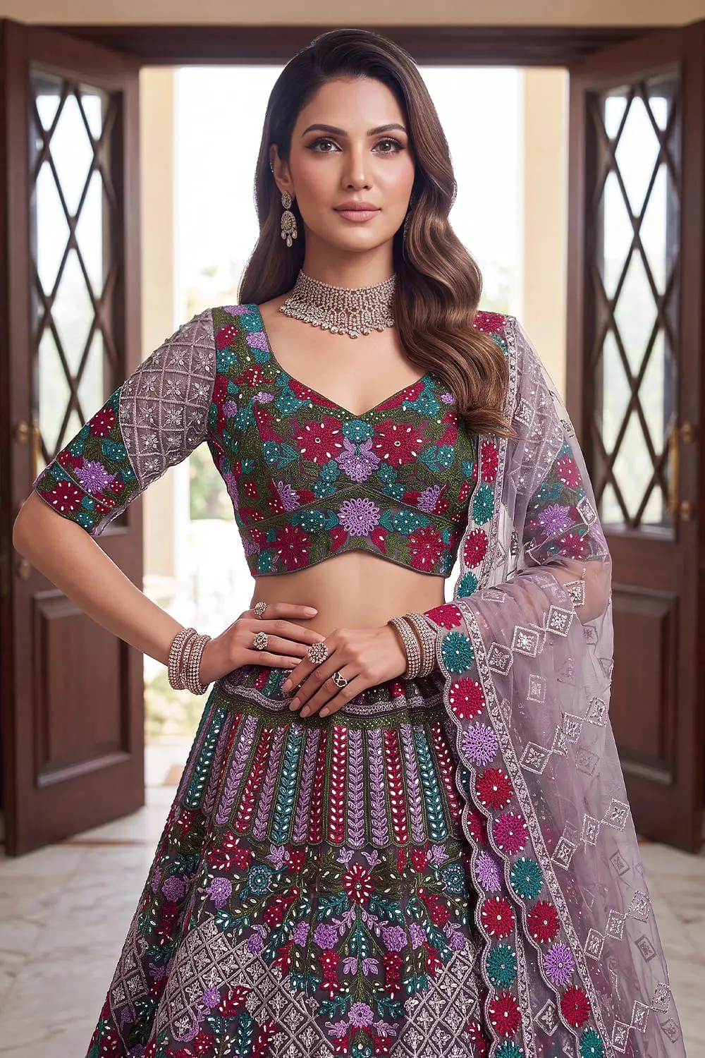 Close up of hand mirror work, chain embroidery and zircon detail on the purple net lehenga
