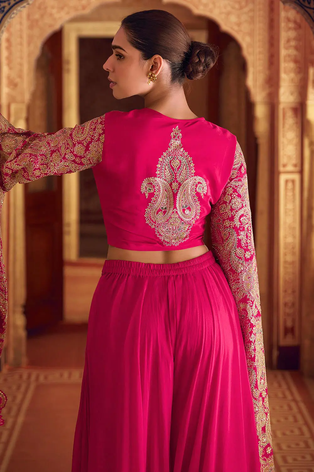 Back view of stitched free size pink fusion dress with heavy embellishments