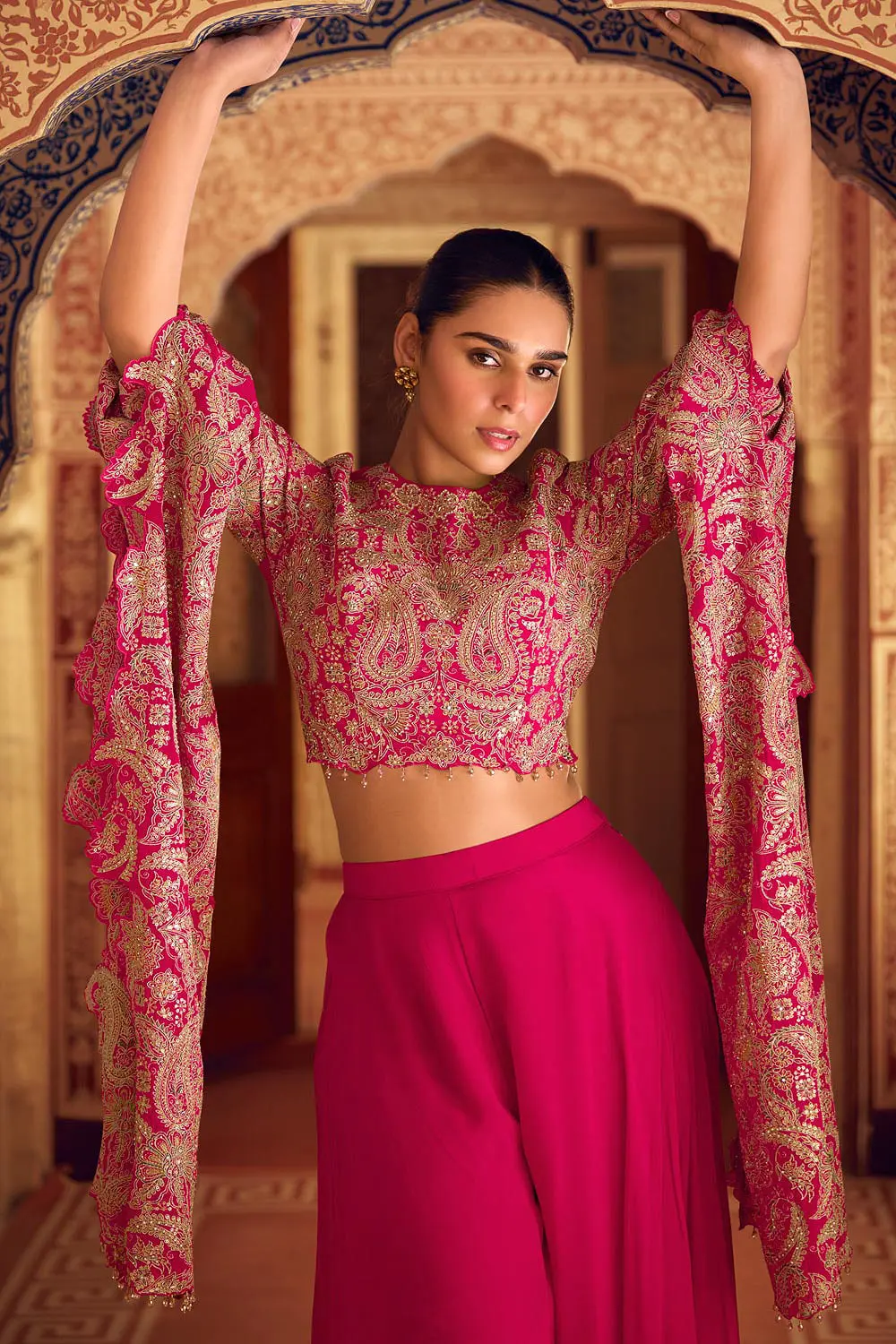 Front embroidery pattern on vibrant pink party wear ethnic suit