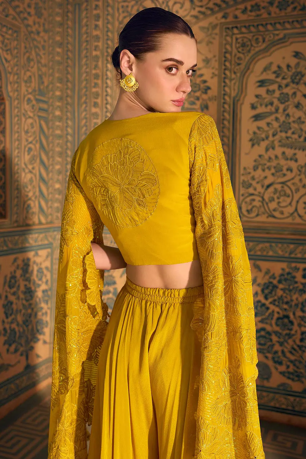 Back view of mustard crop top showing front-and-back zari embroidery