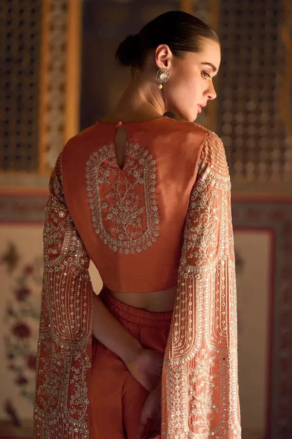 Back view of stitched free size flowy coral party wear suit