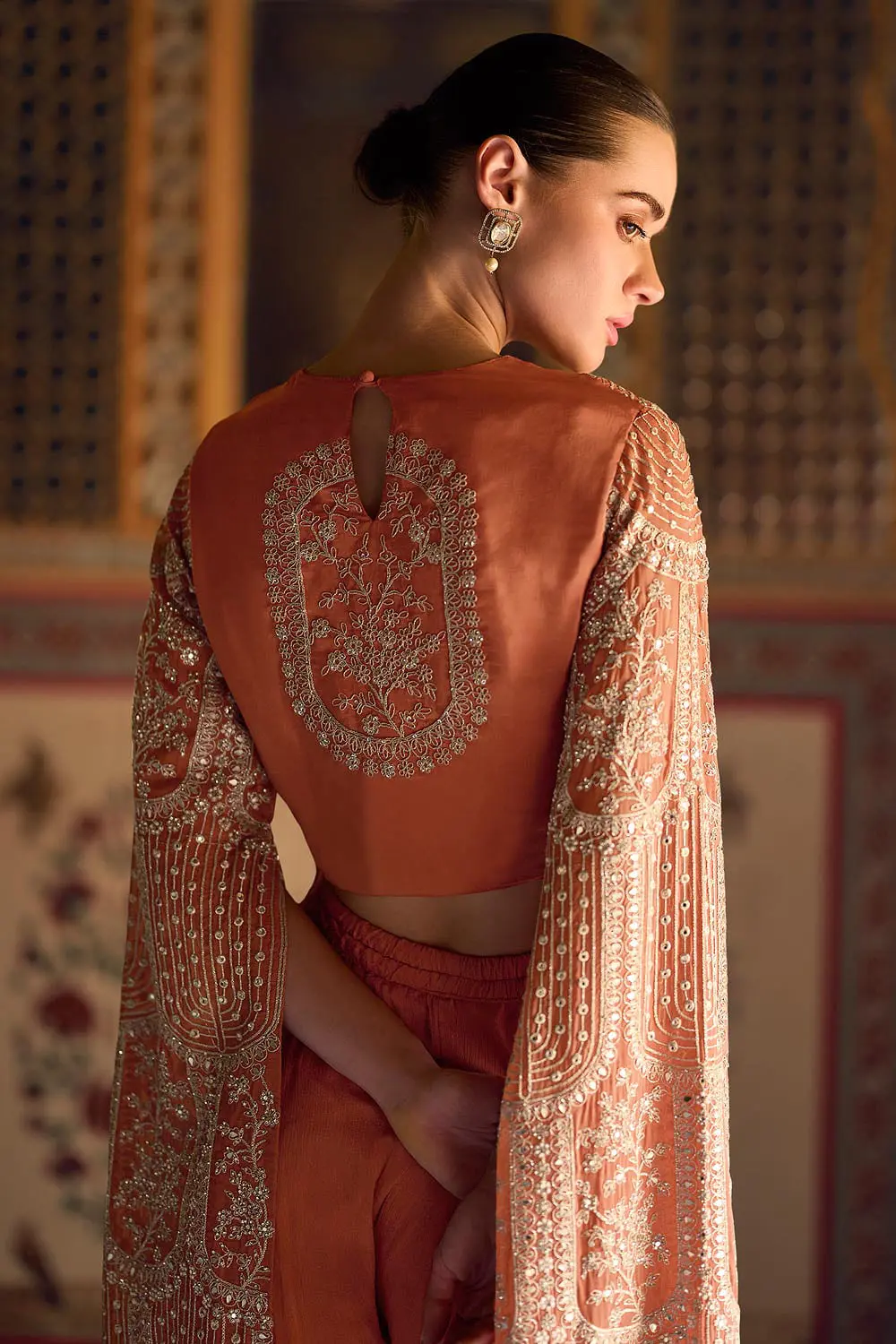 Back view of stitched free size flowy coral party wear suit