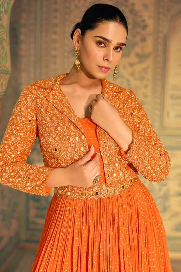 Detailed close-up of the intricate embroidery on the jacket of this premium orange fusion gown.