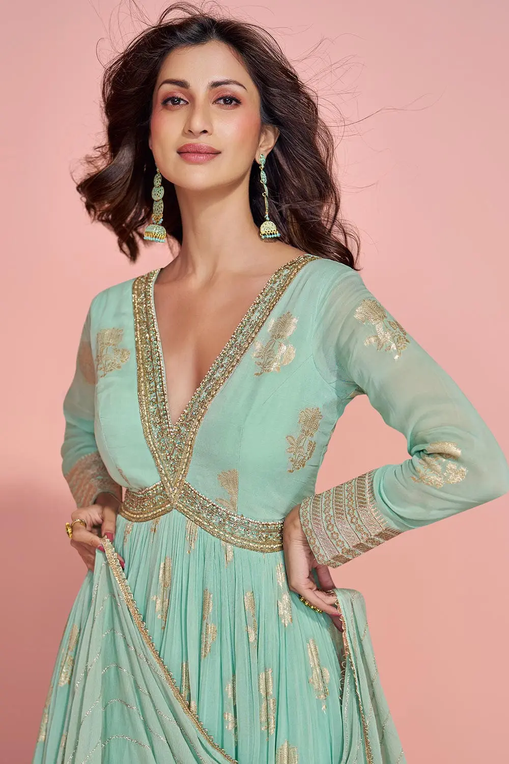Close up of jacquard weave pattern and embroidery on mint green anarkali gown surface